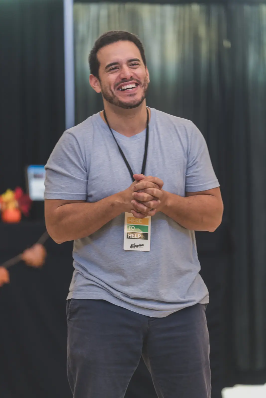 A smiling Kingdom House volunteer ready to help guests find their way