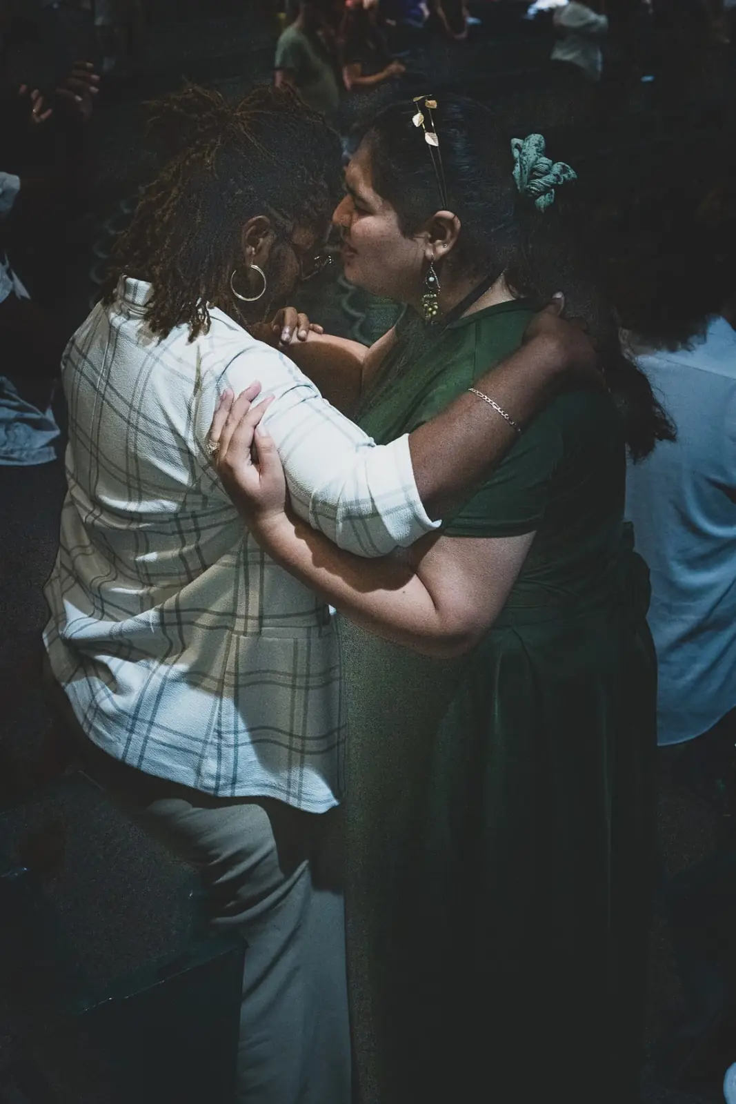 Two women embracing during a Sunday service at Kingdom House