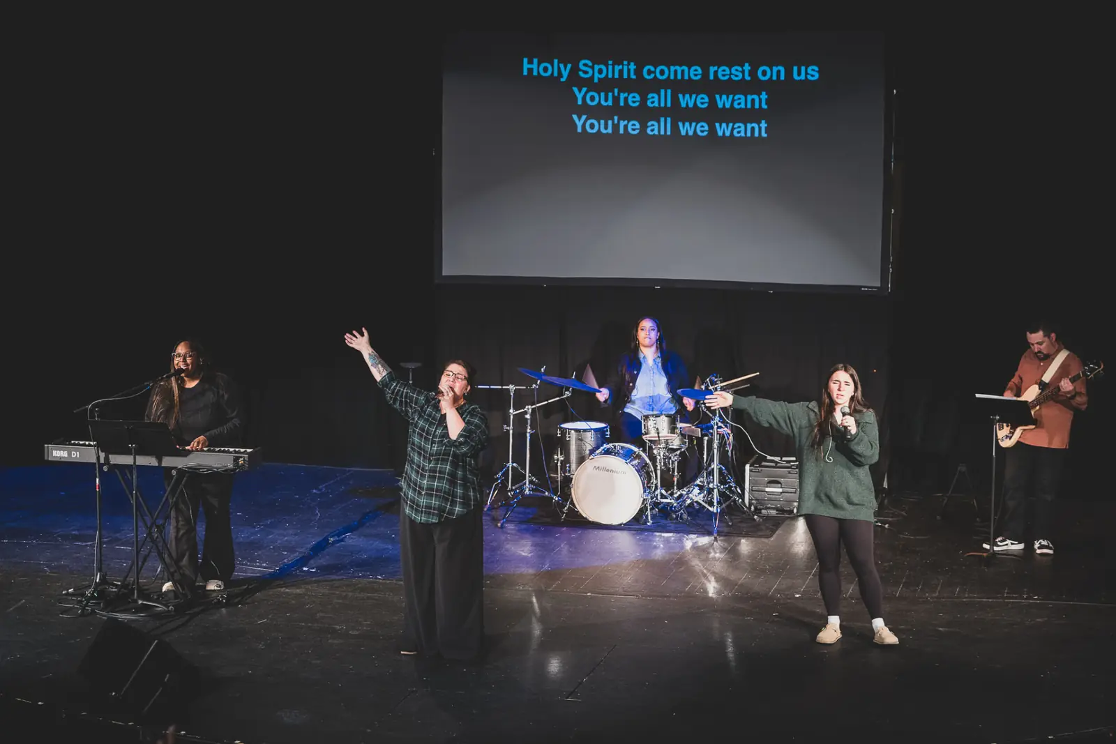 The Kingdom House worship team leading a song on stage