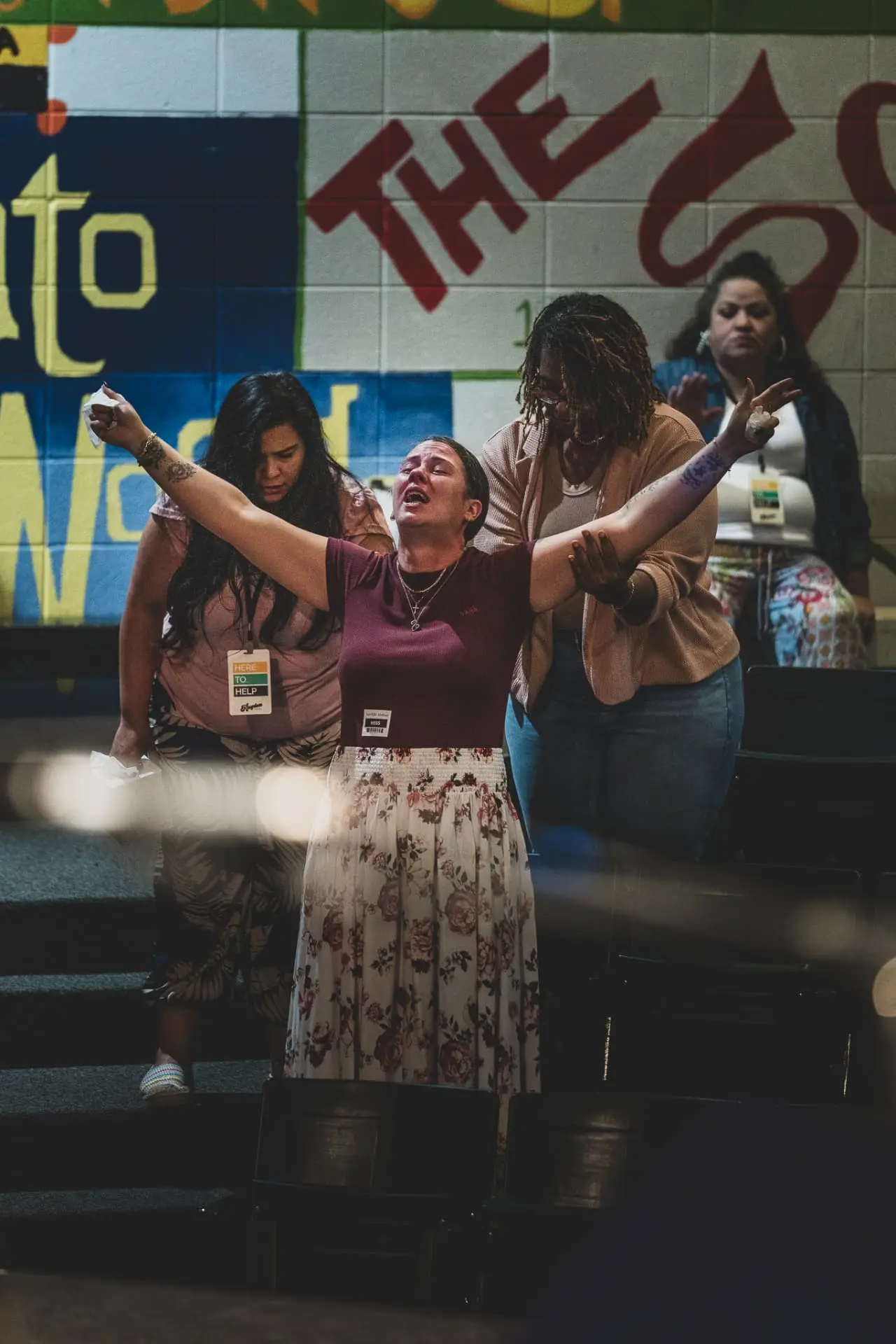 A woman worshipping with hands raised